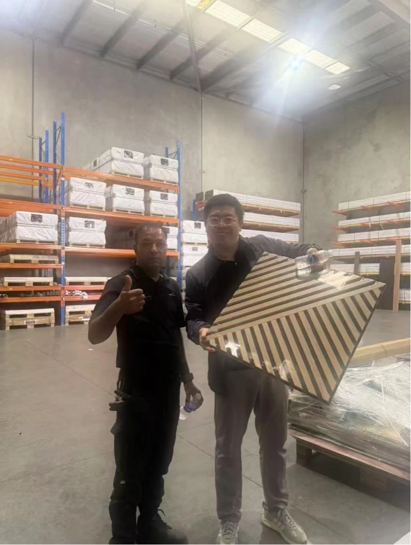 Team members from Dongguan MuMu Woodwork Co., Ltd. with Brisbane trade partners, reviewing geometric panel system samples.